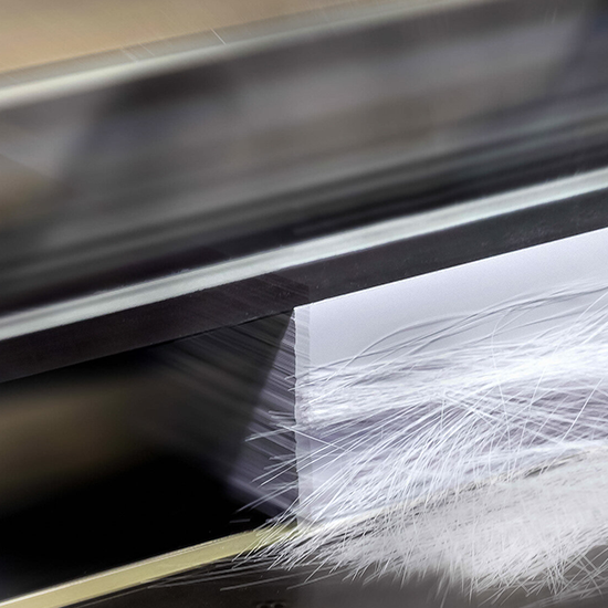 Up close photo of a stack of paper being cut