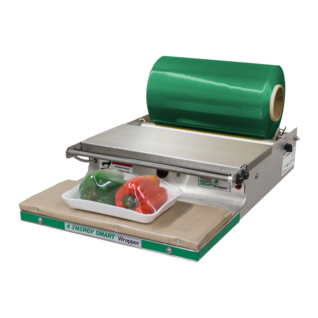 Heat Seal 700ES Mini Energy Smart Wrapper with green film roll and wrapped produce tray on heated pad