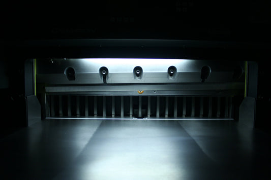 Close-up of Champion 305 TC knife bar and bright LED cut-line inside the clamp area