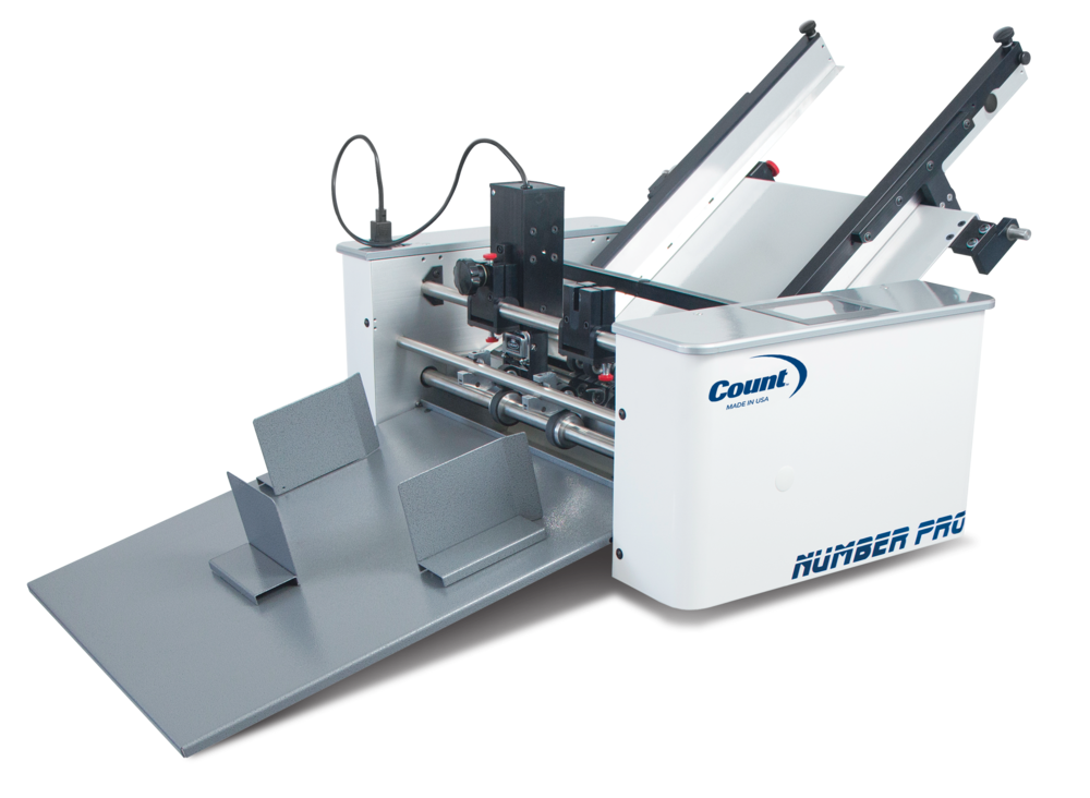 Count NumberPro numbering machine with dual angled feed trays and metal delivery table, featuring a white body labeled 'Number Pro' and 'Made in USA