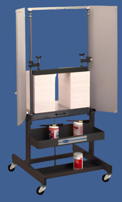 Challenge Paddy Wagon padding press with clamped paper stacks, mobile base, and integrated storage shelves for glue and tools