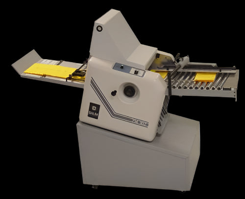 BAUM 714XLT Ultrafold tabletop paper folder configured as a 2nd station unit with folded yellow sheets exiting to the conveyor tray.