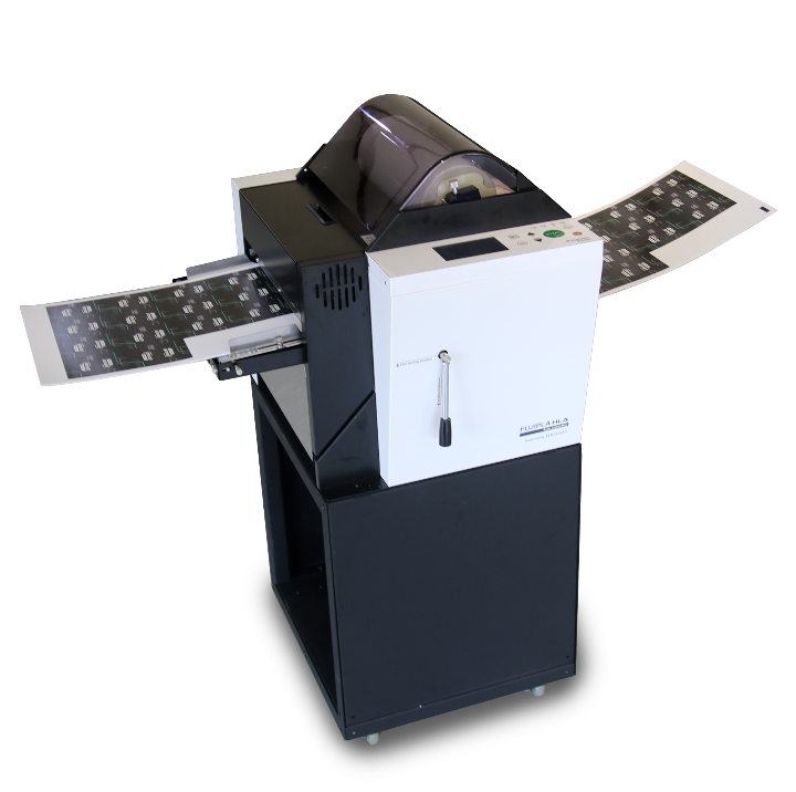 Dry-Lam HLA-2301 Automatic Laminator on a stand, actively feeding and laminating a roll of printed sheets through its front and back trays.