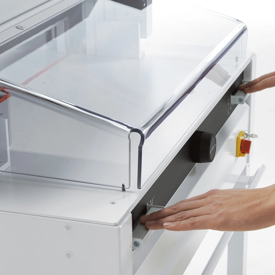 Hands operating the Triumph 4855 safety guard near the cutting area