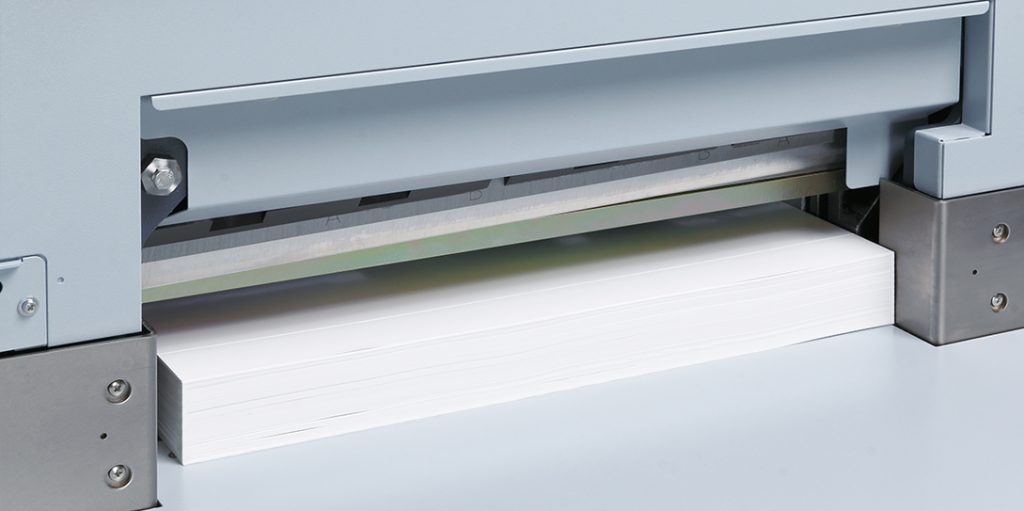 Horizon APC-450 cutter blade positioned above paper stack – precision guillotine blade for clean, accurate trimming in bindery operations.