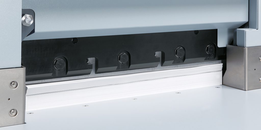Close-up of Horizon APC-450 cutter blade trimming paper – high-precision guillotine action for clean, professional cuts in print finishing.