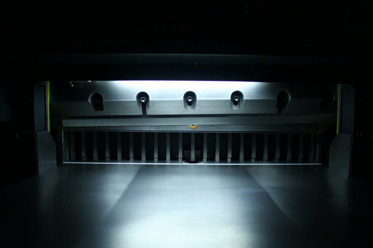 Close-up of Champion 305 TC knife bar and bright LED cut-line inside the clamp area