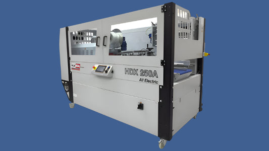 Heat Seal HDX250A All-Electric shrink wrapper, shown from right-side angle with clear safety panels and integrated touchscreen controls.