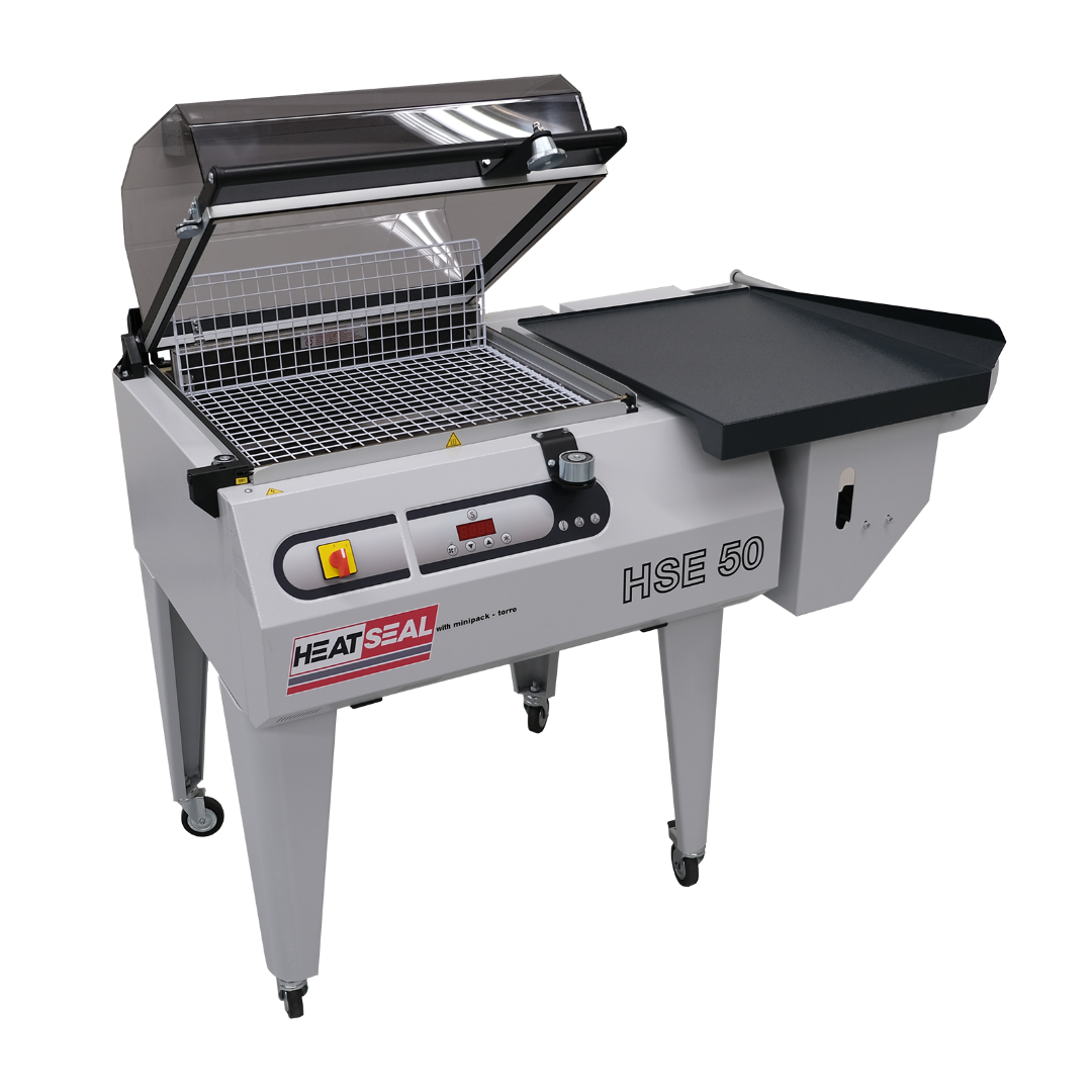 Heat Seal HSE50 shrink wrap system with chamber hood open and integrated sealing table, designed for packaging and sealing products efficiently.