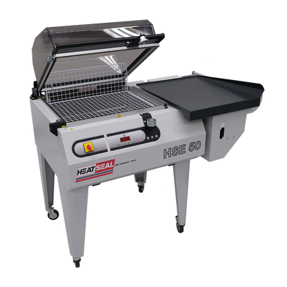 Heat Seal HSE50 shrink wrap system with chamber hood open and integrated sealing table, designed for packaging and sealing products efficiently.