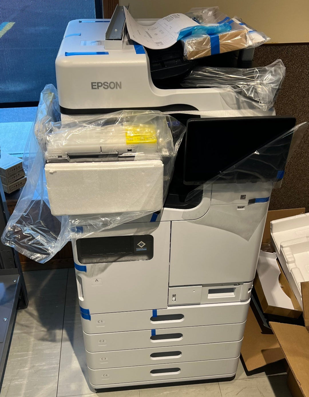 Epson printer in a room with plastic wrapping