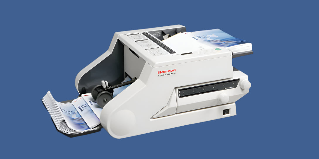 Horizon PF-P3110 Paper Folder with compact design, top paper feed tray, and front output tray displaying folded brochures in progress