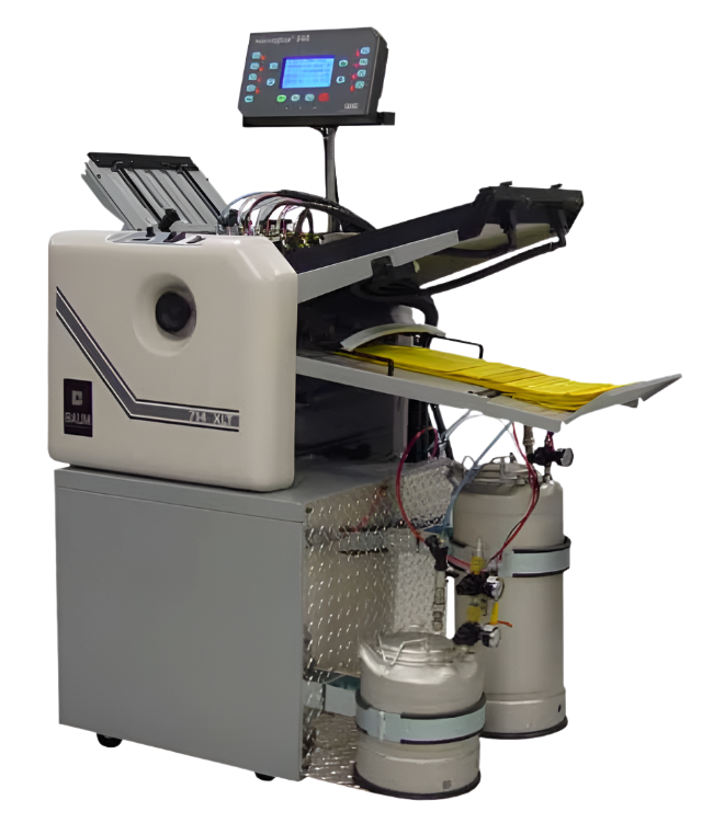 BAUM 714XLT Microgluer folder-gluer system with control panel, gluing tanks, and yellow sheets in the output tray
