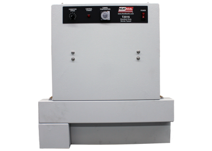 Front view of the Heat Seal T2016 compact shrink tunnel, featuring control panel with conveyor speed, power, and temperature settings.