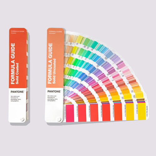 Pantone Formula Guide – Coated + Uncoated (GP1601B) shown open and closed, featuring a full fan of solid spot color swatches for precise color matching in print and design applications.